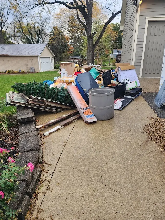 Dumpster being loaded with debris for Estate Cleanout Dumpster Rental in Landis